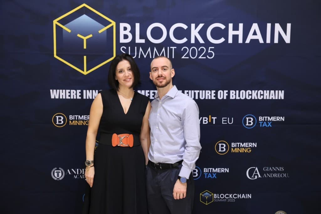 Two guests in front of the Blockchain Summit 2025 backdrop.