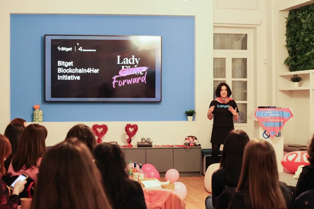 A speaker presenting the Bitget Blockchain4Her initiative to an audience.